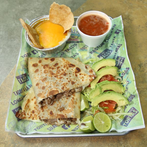 El Vagoncito Chilango's quesadilla with beef, cheese, avocado, lime, salsa, and cheese dip.